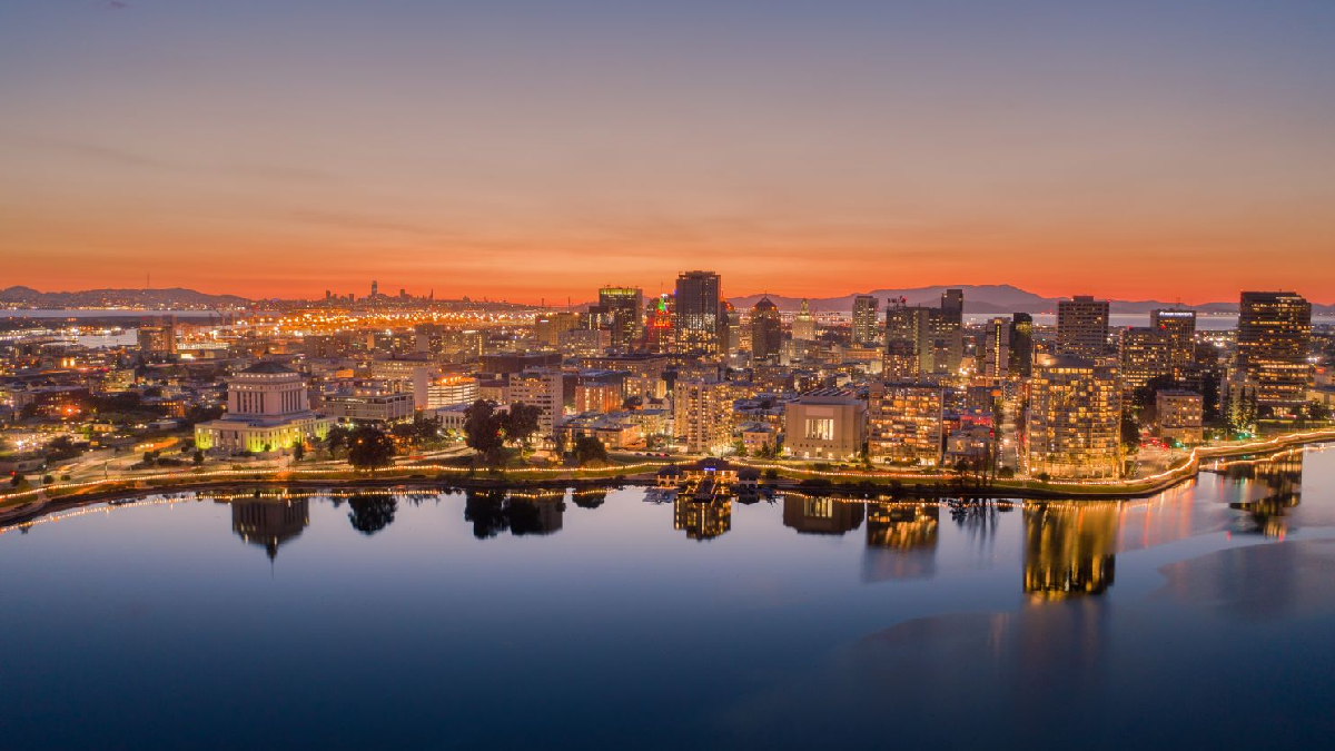 Chauffeur opening limousine door at Oakland airport for luxury car service